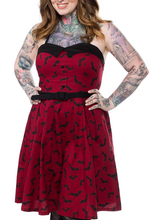 Load image into Gallery viewer, front view of Red spaghetti straps above the knee dress with black bat sihouette repeat pattern all over with attached adjustable black belt.
